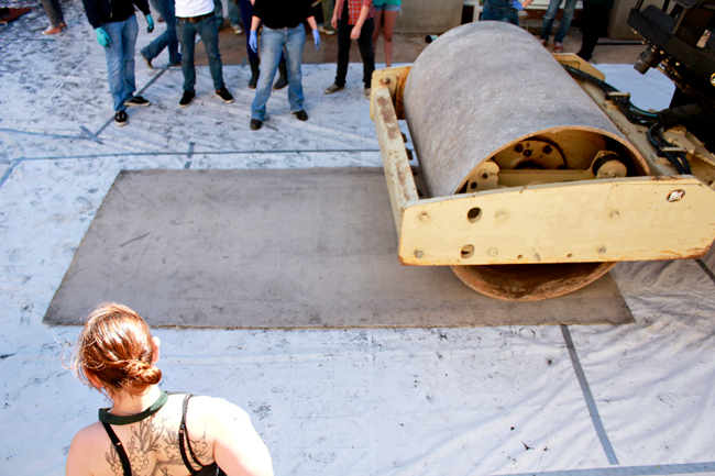 Collesge of Fine Arts students practice woodblock printing by using a steamroller at Explore UT on Saturday.