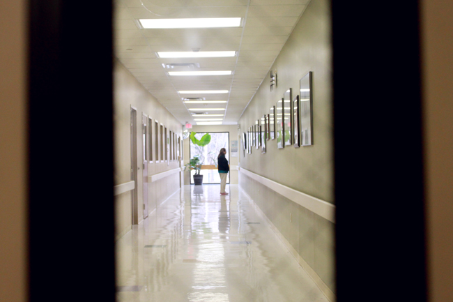 A woman stands in the hallway of University Medical Center Brackenridge, Saturday afternoon. A Friday revision of a federal mandate exempts religiously-affiliated organizations, such as the Brackenridge hospital, from covering contraceptive service costs for employees.