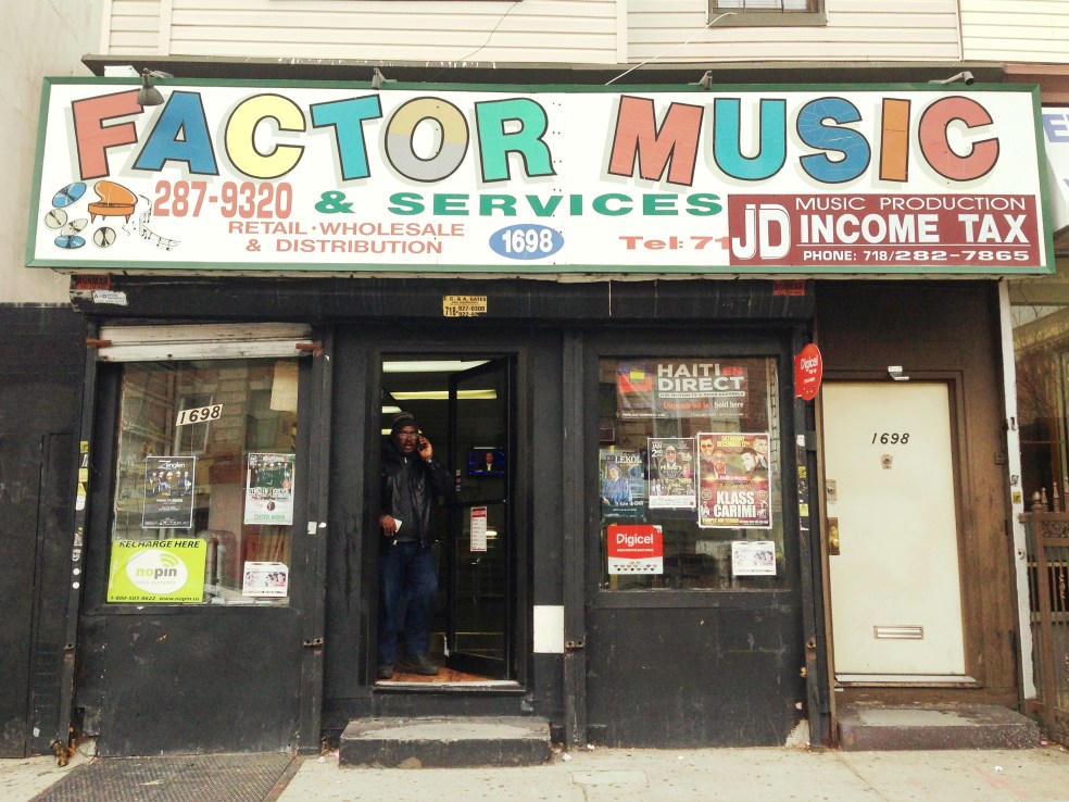 A customer walks out of Factor Music while making a phone call.
